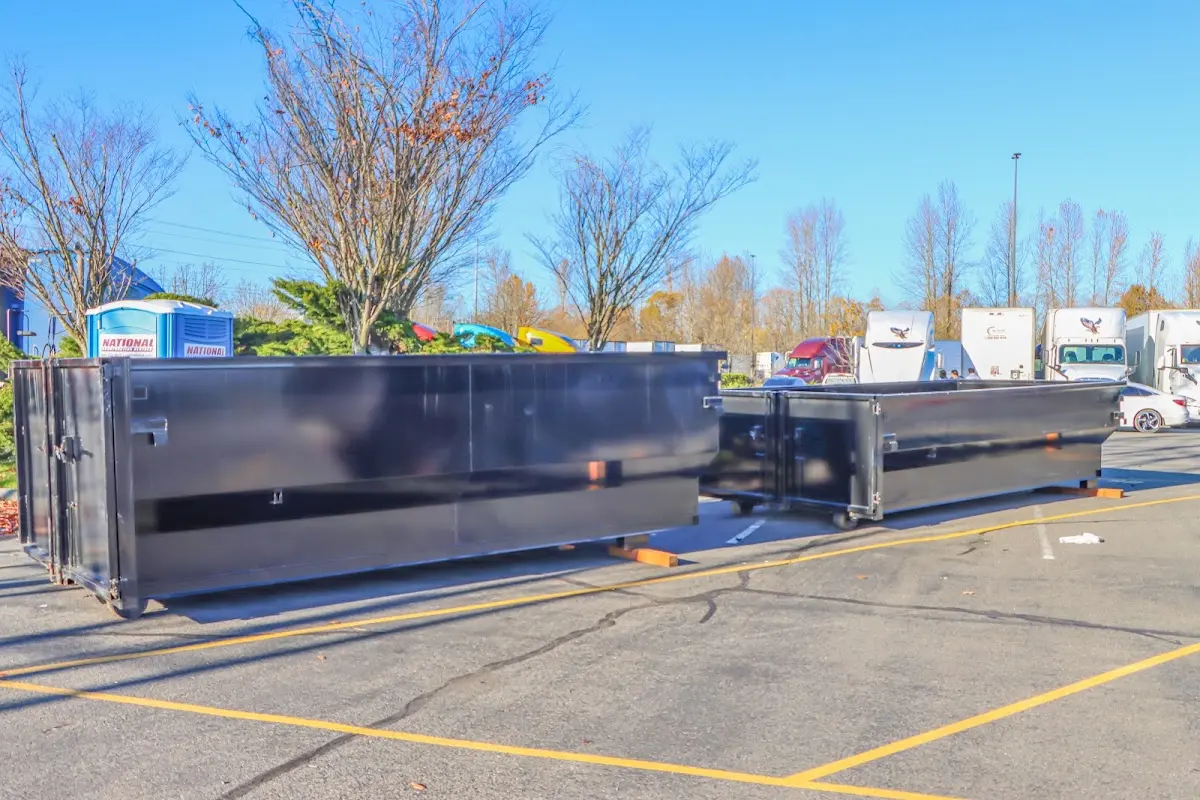 Professional dumpster rental service with roll-off container on residential driveway in Coshocton